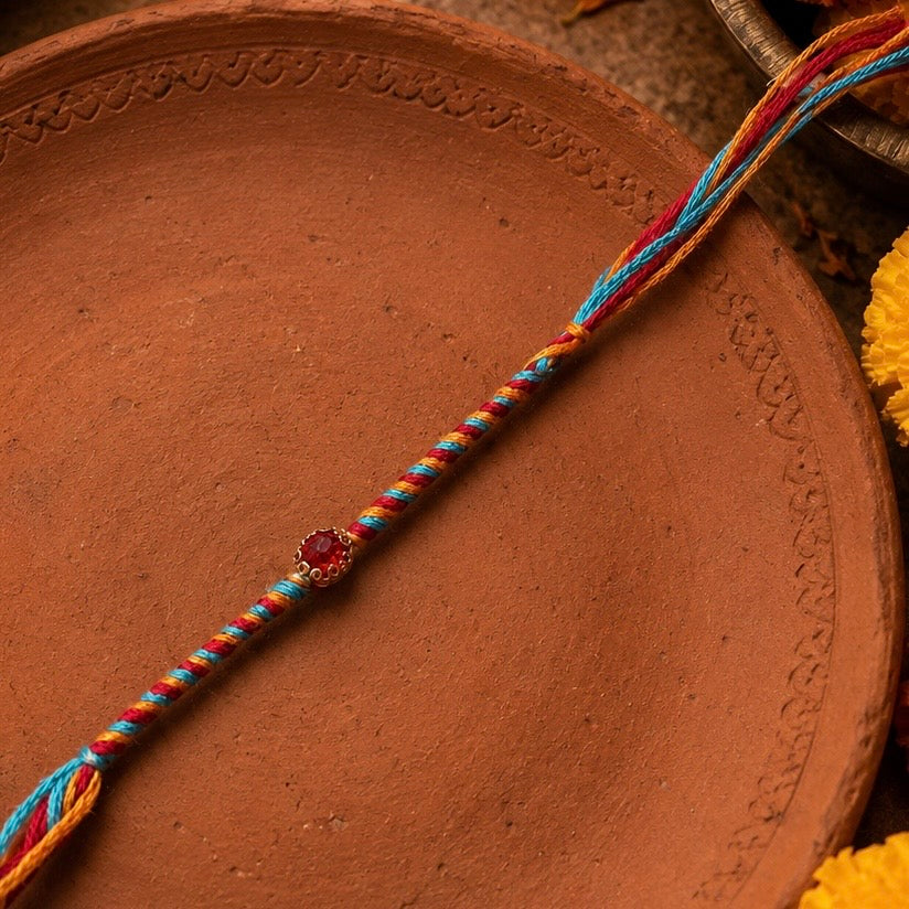 Multicolor Thread Rakhi with Red Stone