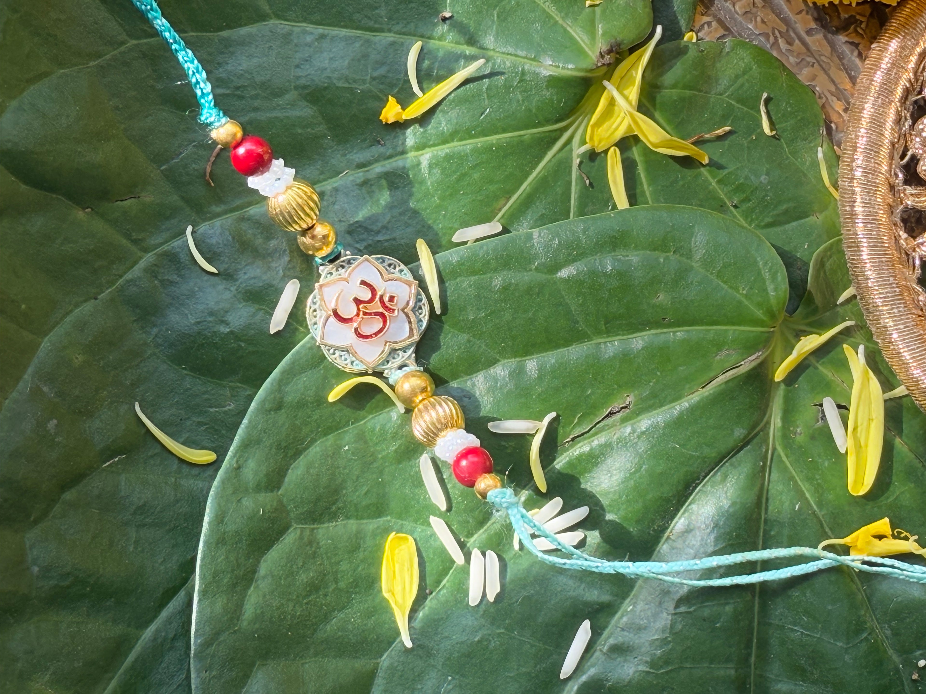 OM WITH MOTHER OF PEARL RAKHI